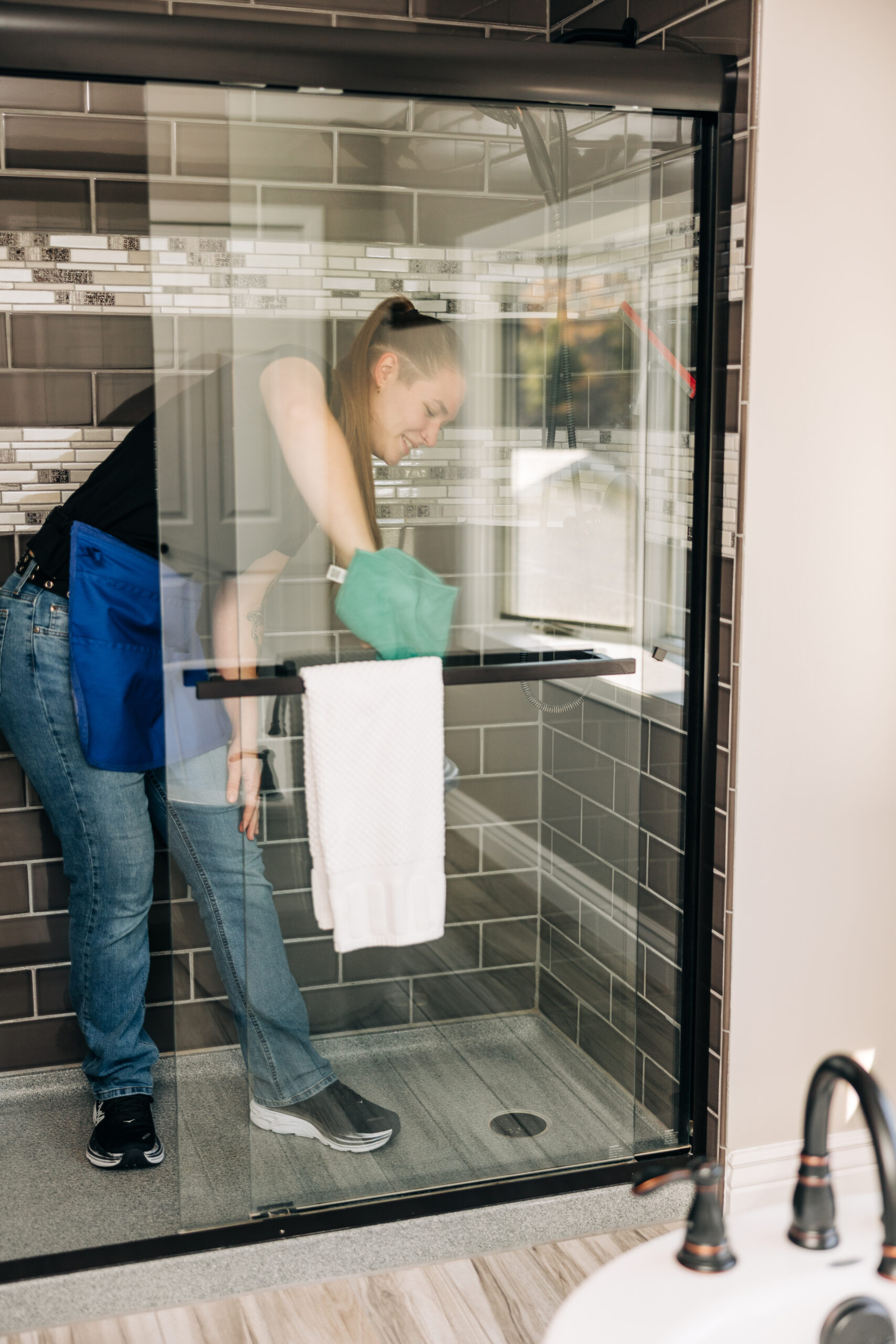 Professional cleaning team member using fresh microfiber cloths for every room in a residential home.