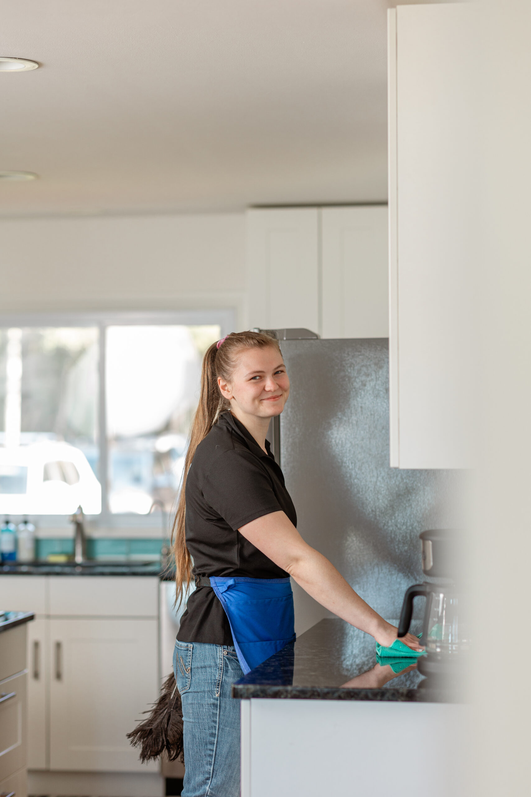 Orchard technician wiping kitchen counters during a Frankfort house cleaning