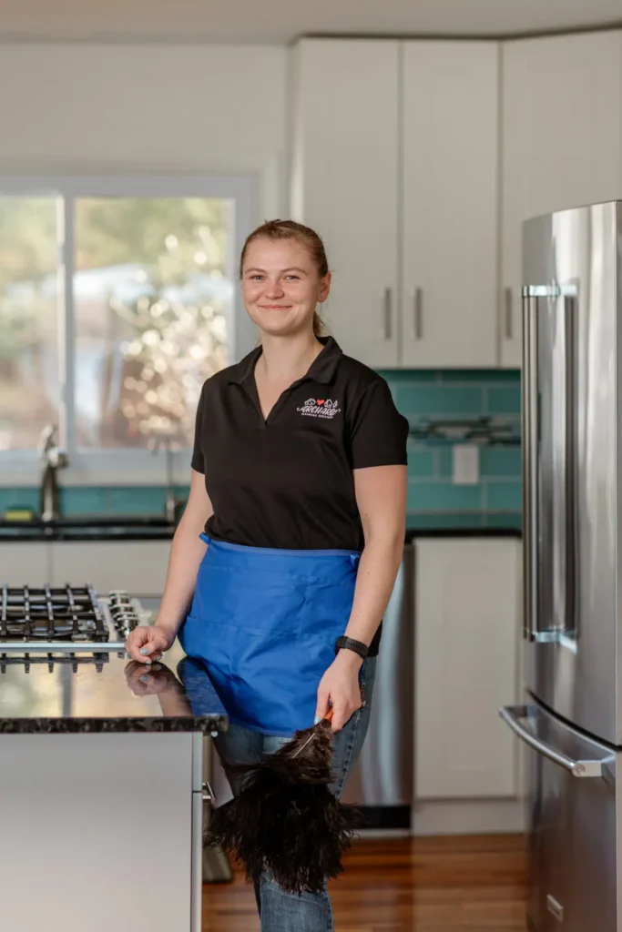 Orchard Cleaning technician dusting a kitchen in Traverse City (Grace Hudson Photography) Orchard Cleaning Services technician dusting a kitchen in Traverse City, Michigan